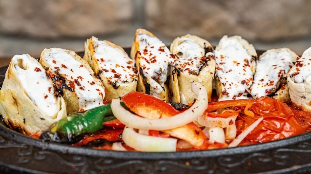Close-up of sliced beyti kebab pinwheel rounds at Lalezar