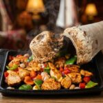 Testi kebab poured from a cracked clay jug at Lalezar KL