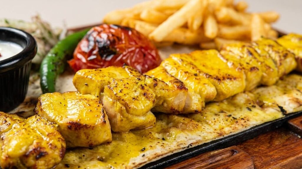 Close-up of golden saffron joojeh kebab